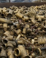 A pile of yellow brass scrap valves and fittings