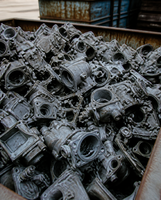 Zinc die cast scrap parts heaped in a steel bin